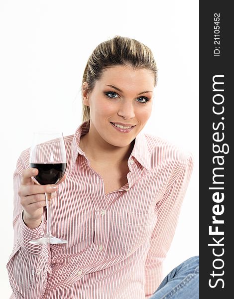 Attractive young woman holding a glass of red wine