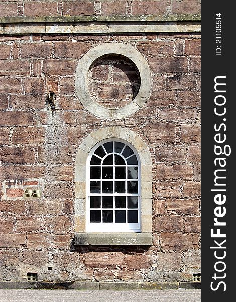 Detail of wall and window on large brick building. Detail of wall and window on large brick building