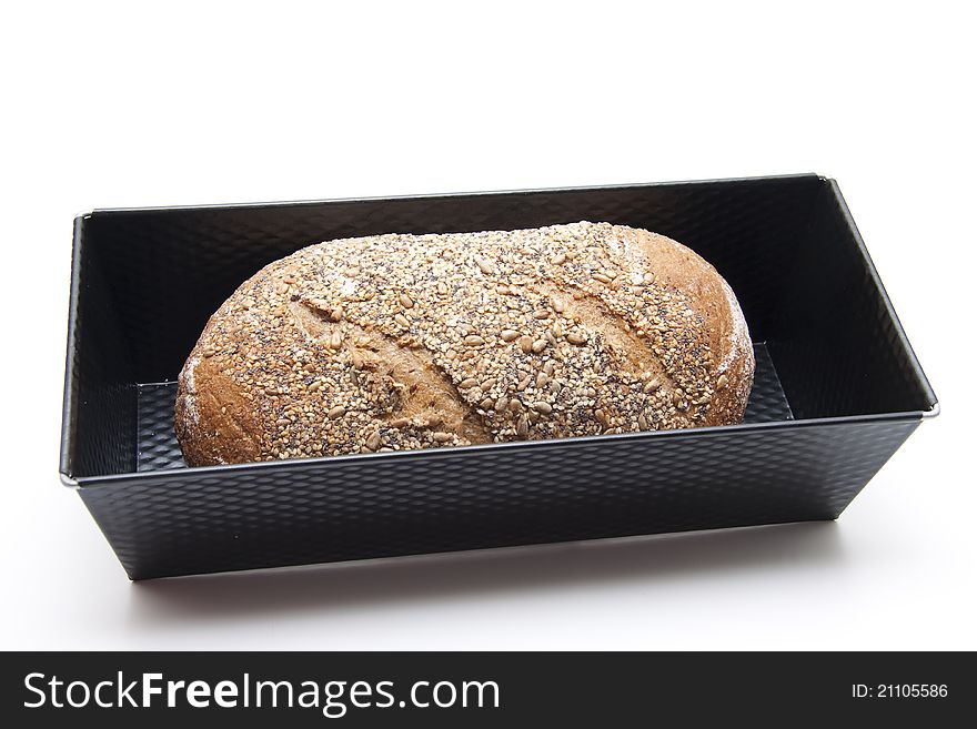 Bread baking tin and more grain bread on white background