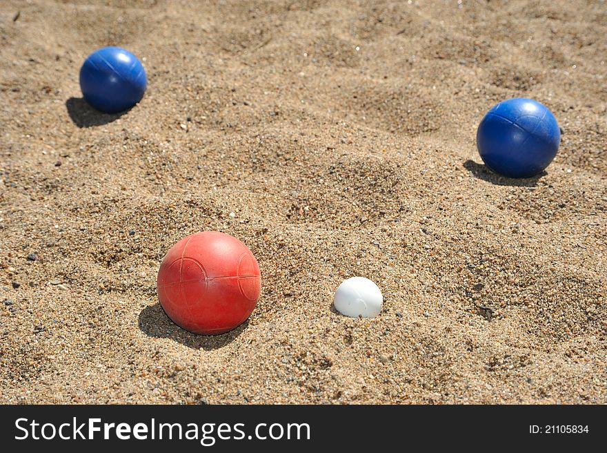 Bocce balls lie at rest on beach. Bocce balls lie at rest on beach