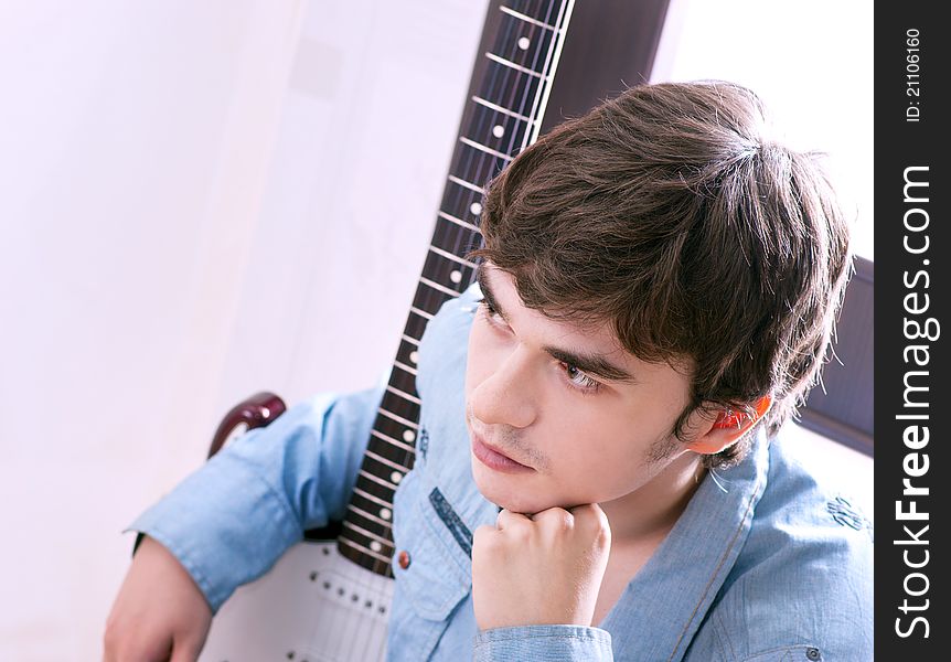 Young handsome guy with a guitar