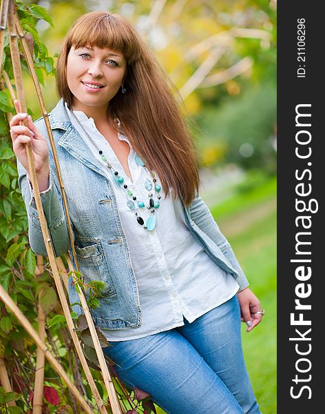 Portrait of young beautiful woman in a park