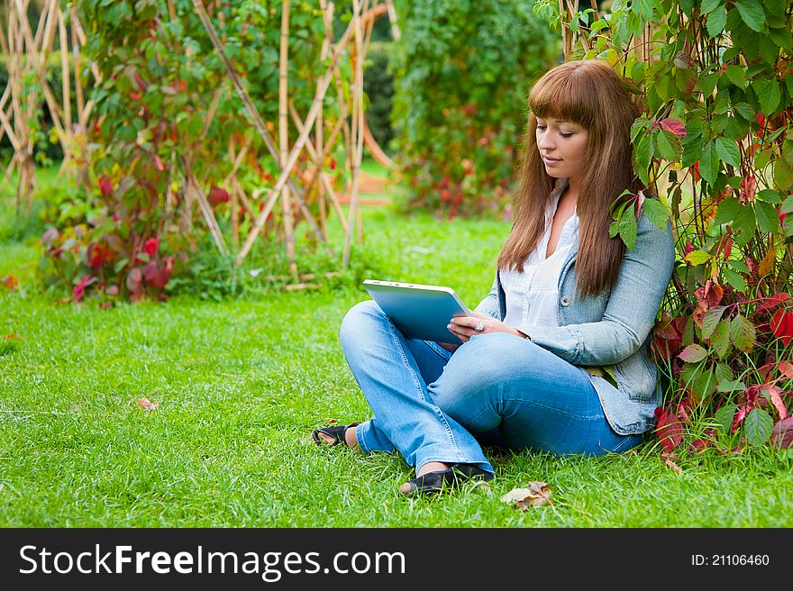 Young woman reading in tablet pc
