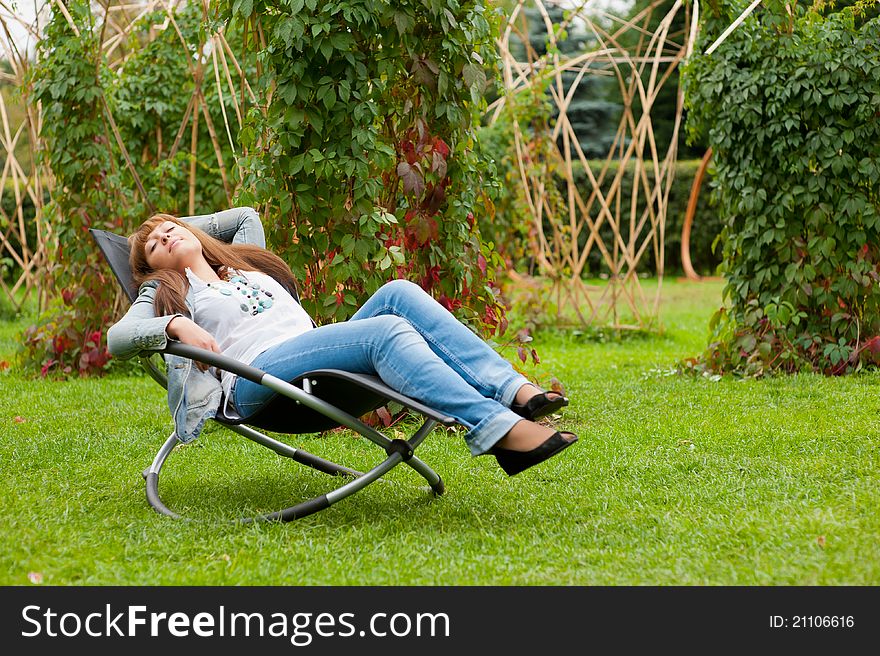 Woman resting in a park on the rocking chair