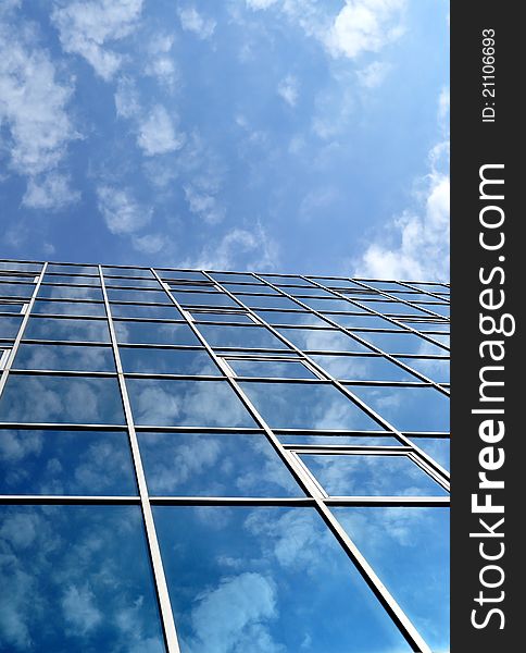 High-rise glass building with sky and clouds reflection. High-rise glass building with sky and clouds reflection