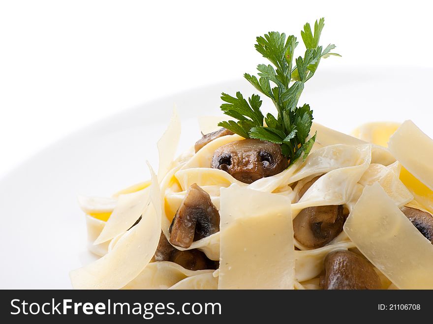 Closeup of plate of Tagliatelle with champignon, cheese creamy sauce and parmesan cheese. Closeup of plate of Tagliatelle with champignon, cheese creamy sauce and parmesan cheese