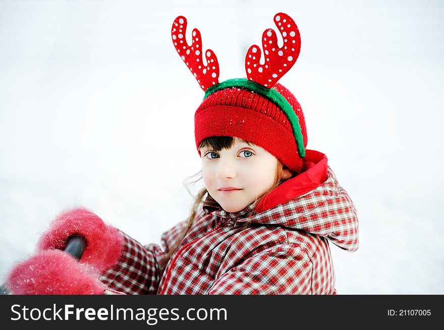 Outdoors portrait of adorable child girl in Christmas outfit. Outdoors portrait of adorable child girl in Christmas outfit