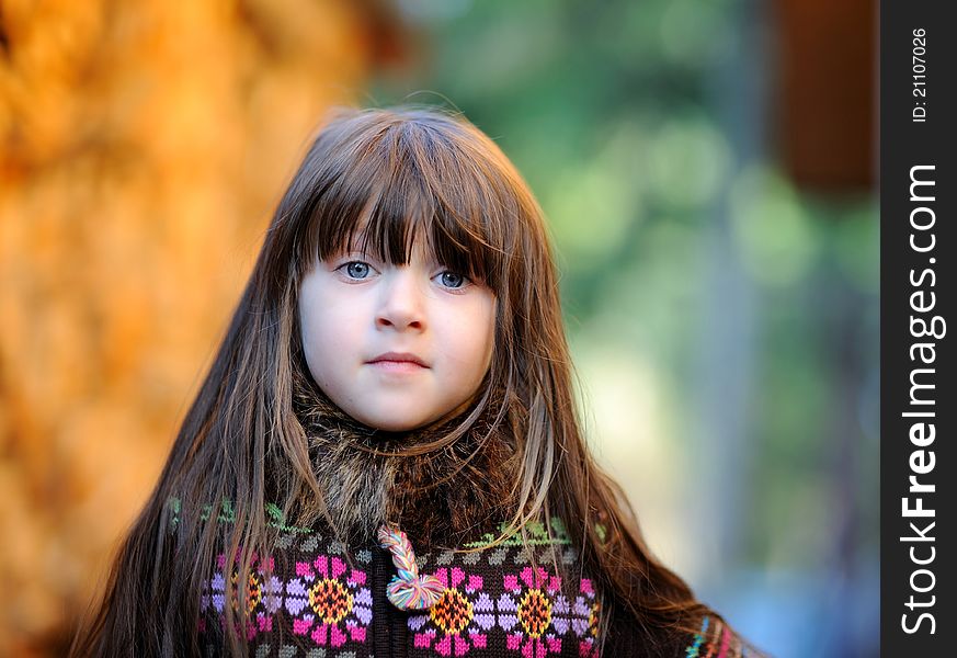 Outdoors portrait of adorable little brunette girl with loose hair. Outdoors portrait of adorable little brunette girl with loose hair