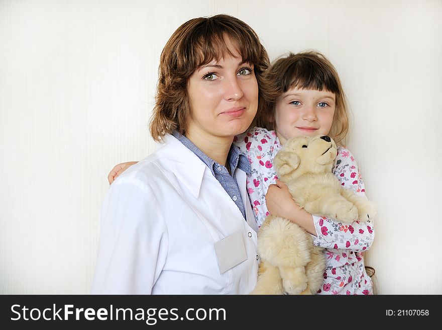 Young Female Doctor With A Cute Little Patient