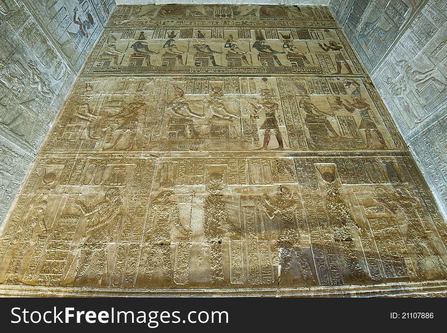 Hieroglyphic carvings and paintings on the interior walls of an ancient egyptian temple. Hieroglyphic carvings and paintings on the interior walls of an ancient egyptian temple