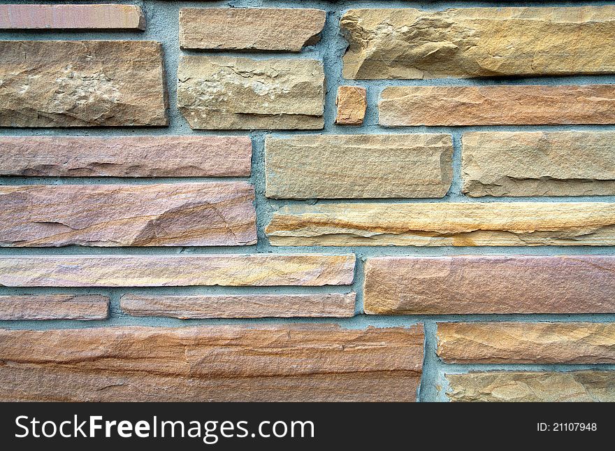 Close-up of colorful background sandstone brick wall. Close-up of colorful background sandstone brick wall