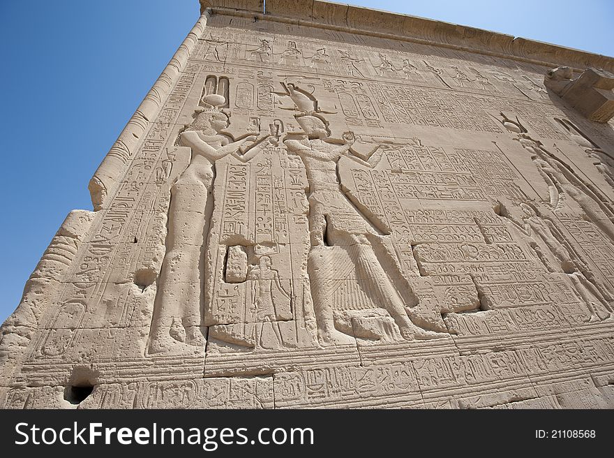 Hieroglyphic carvings on the exterior walls of an ancient egyptian temple. Hieroglyphic carvings on the exterior walls of an ancient egyptian temple