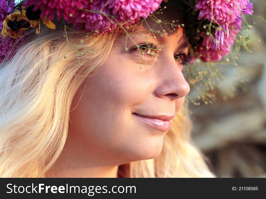 Young woman in corn haystack with wreath