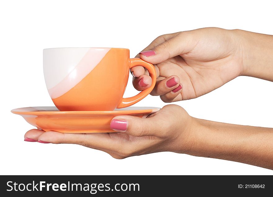 A cup in a hand is isolated on a white background