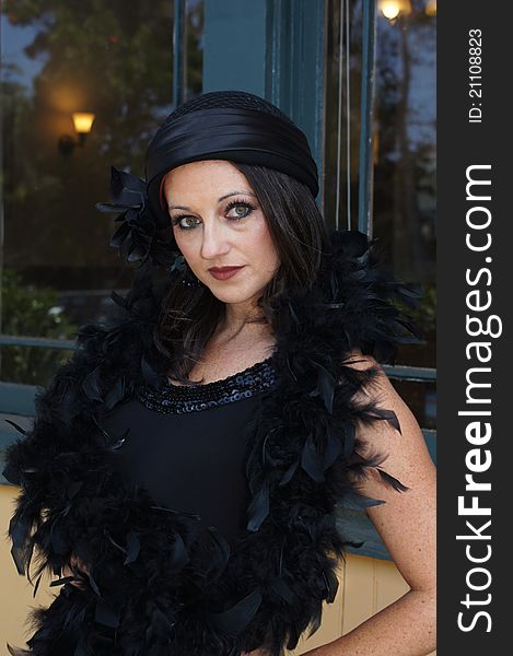 Beautiful Woman modeling clothing and accessories from 1930/40's Vintage clothing, hat, and a boa standing at old train station waiting to train. Beautiful Woman modeling clothing and accessories from 1930/40's Vintage clothing, hat, and a boa standing at old train station waiting to train