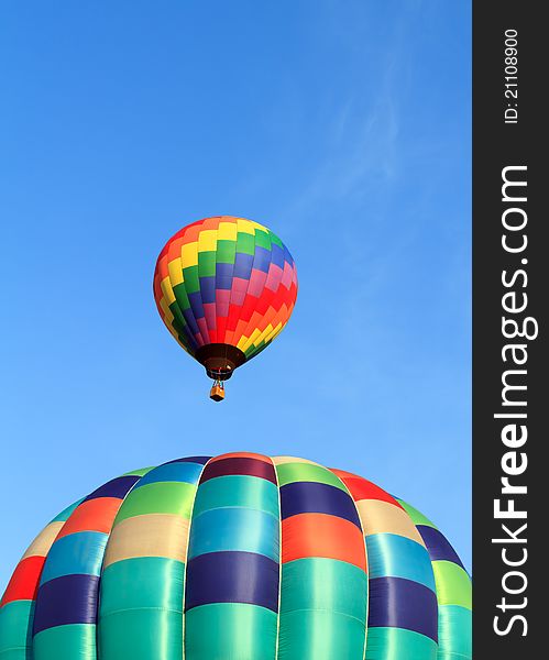 Two hot air balloons over blue sky