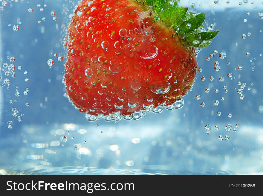 Splashing Strawberry in blue Water background with Bubble