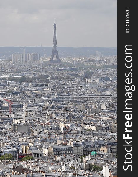 Paris skyline: Eiffel Tower from across Parisan rooftops. Paris skyline: Eiffel Tower from across Parisan rooftops.