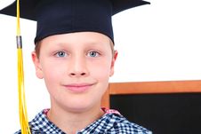 Graduate Boy In Cap With Blackboard In Background Stock Image