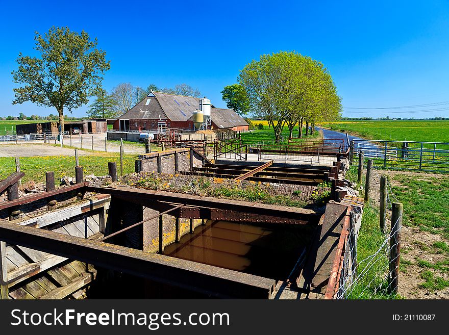 Farm with stream in the countryside on a sunny day