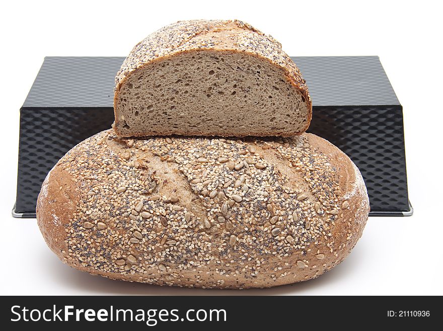 Bread baking tin and more grain bread on white background