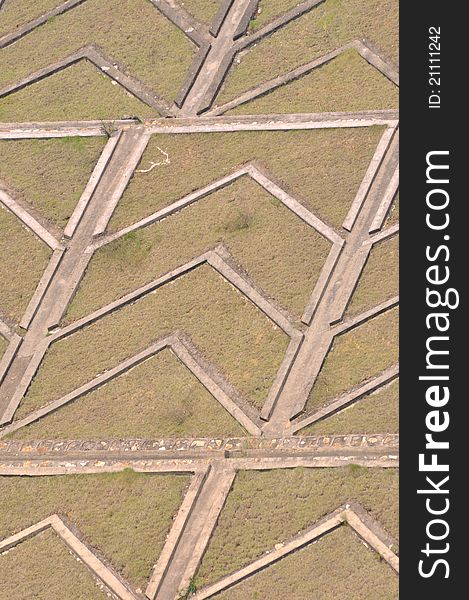 Concrete laying counterfort of water dam slope, with grass surface, shown as industrial architecture or featured background. Concrete laying counterfort of water dam slope, with grass surface, shown as industrial architecture or featured background.