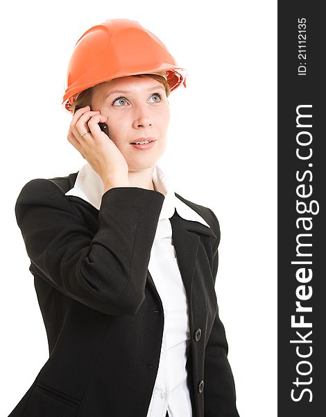 Businesswoman in a helmet with a mobile phone on a white background. Businesswoman in a helmet with a mobile phone on a white background.