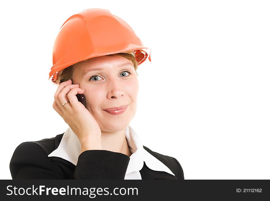 Businesswoman in a helmet with a mobile phone.