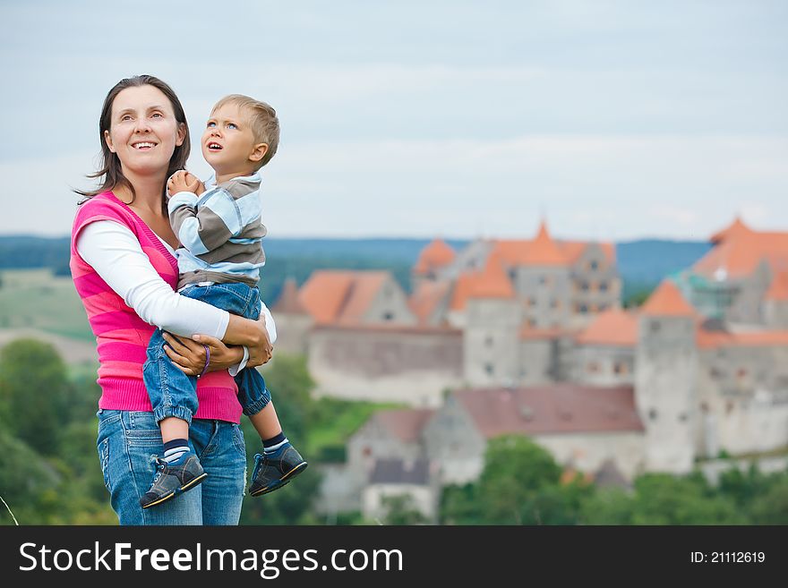 Young travelers. Young mother with her son on a tour of European medieval castles.