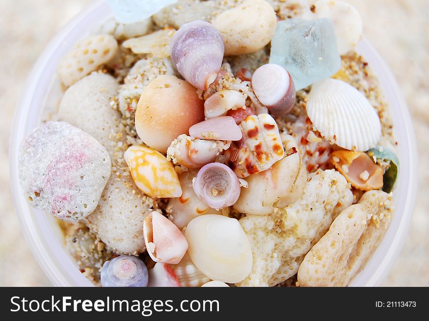 Colorful shells with sand in a cup. Colorful shells with sand in a cup