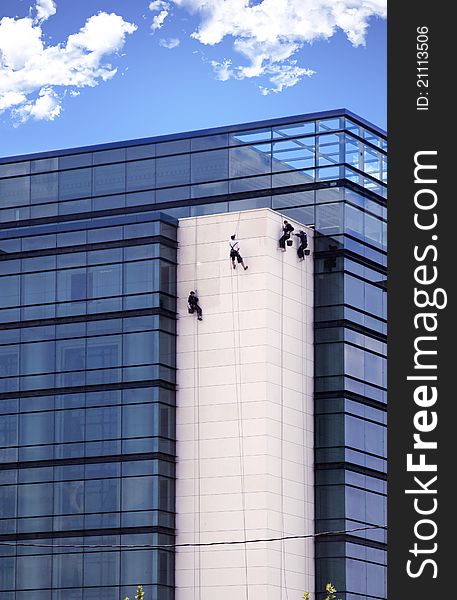 Window washers on tall new  building. Window washers on tall new  building.