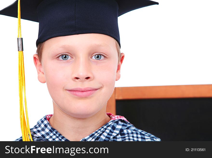 Graduate boy in cap with blackboard in background