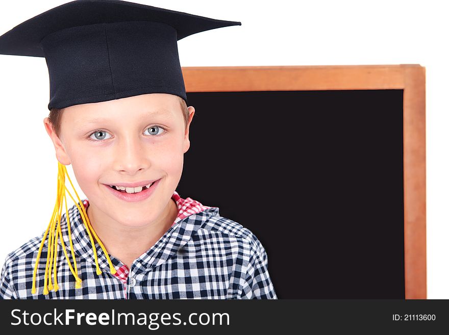 Small graduate boy in cap with blackboard in background
