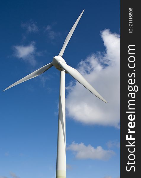 Vertical wind generator on a blue sky background