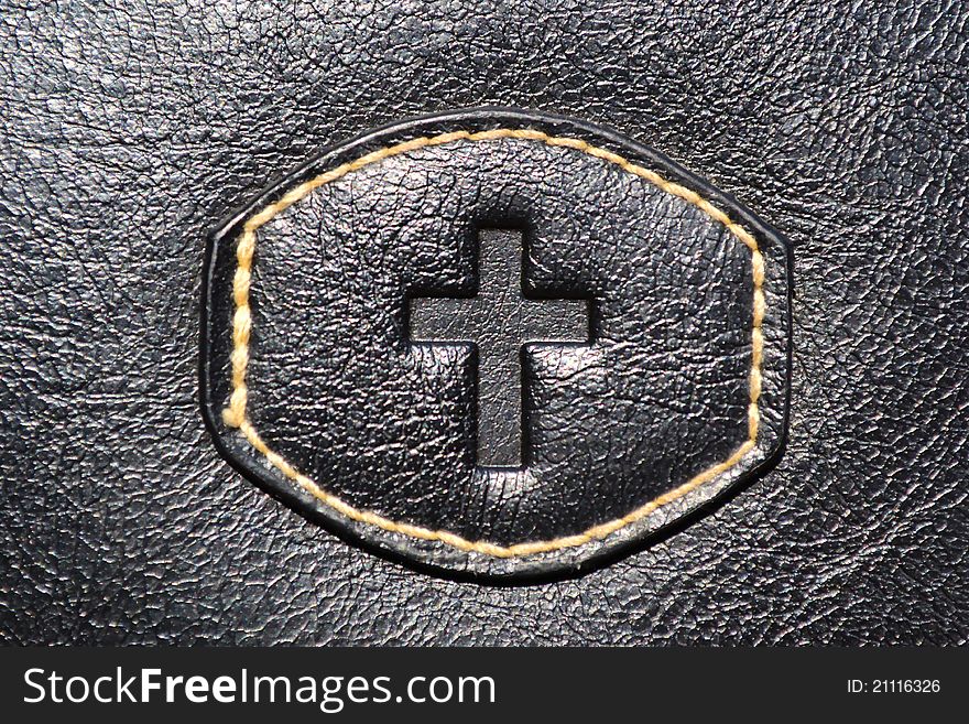 A photo of the cross of Jesus on leather. A photo of the cross of Jesus on leather.