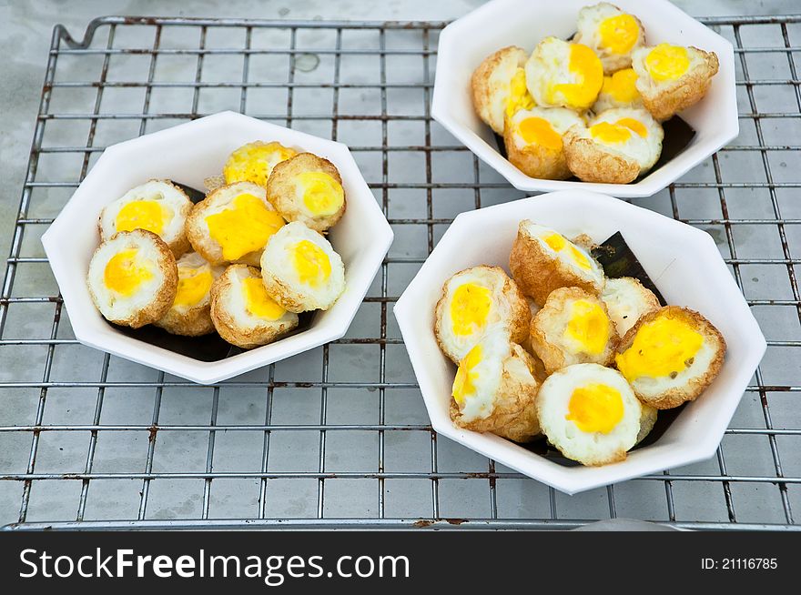 Boiled egg with fried on foam cups.