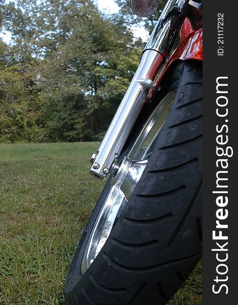 Motorcycle front tire, forward view from ground upwards.