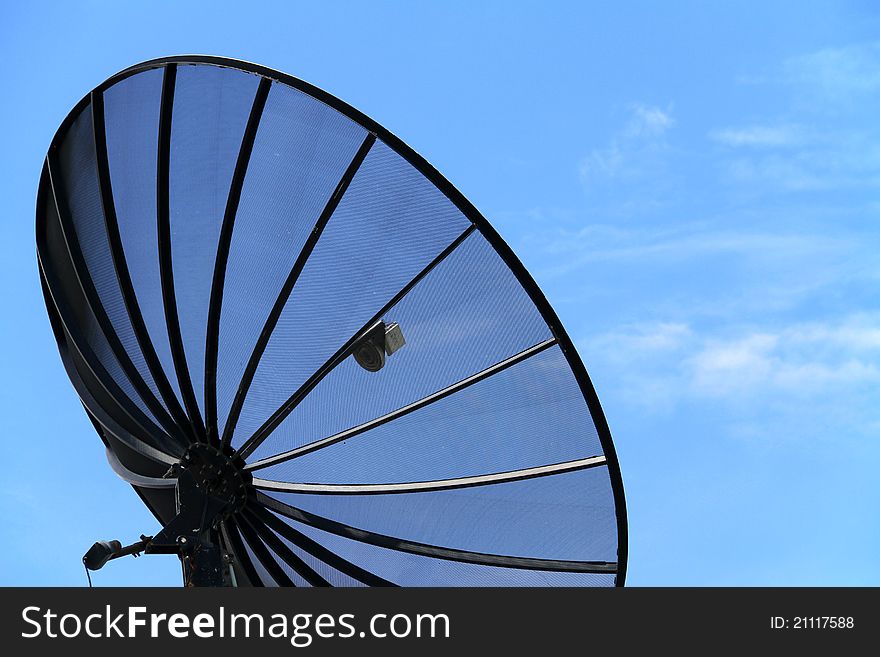 Satellite dish antenna on blue sky background