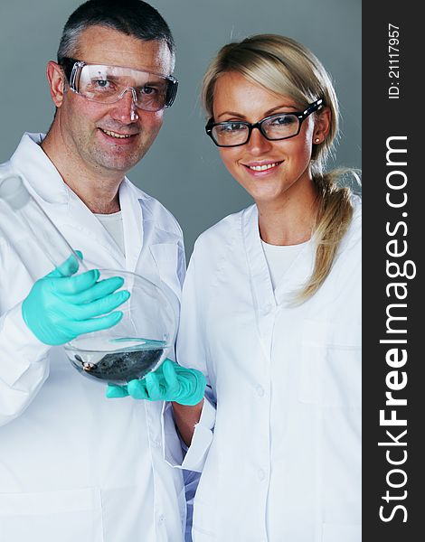 Chemistry researchers holding a secret green chemical substance. Chemistry researchers holding a secret green chemical substance