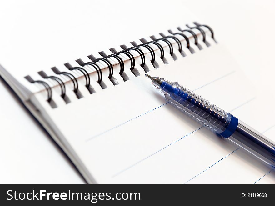 Empty notebook with pen in white background