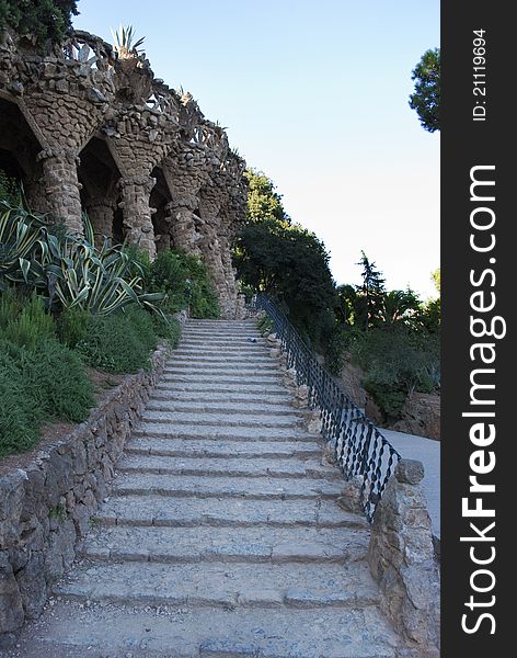 An outdoor stairs made of stones,visitable in the Park Guell in Barcelona