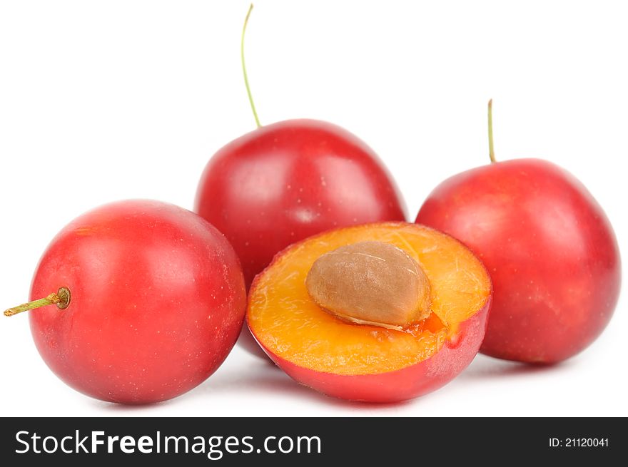 Red cherry plums on white background