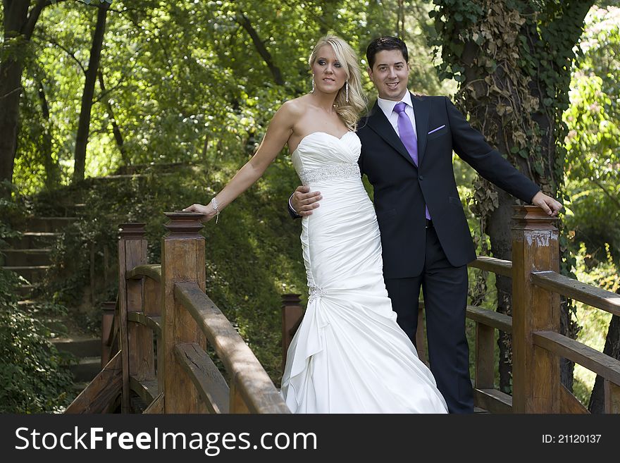 Love on the wooden bridge in Green Forest