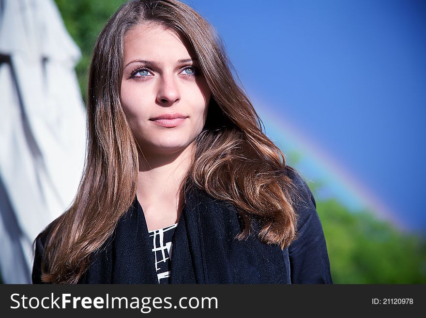 Portrait of a beautiful woman on the background of the rainbow