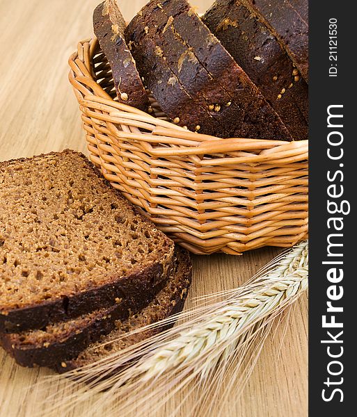 Basket with bread and wheat on the table