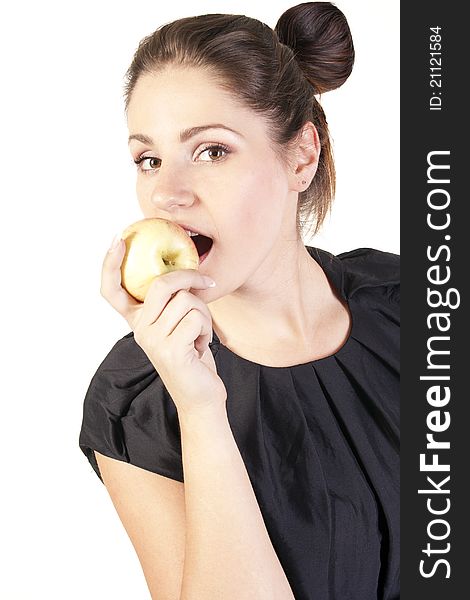 Young woman eating apple in studio