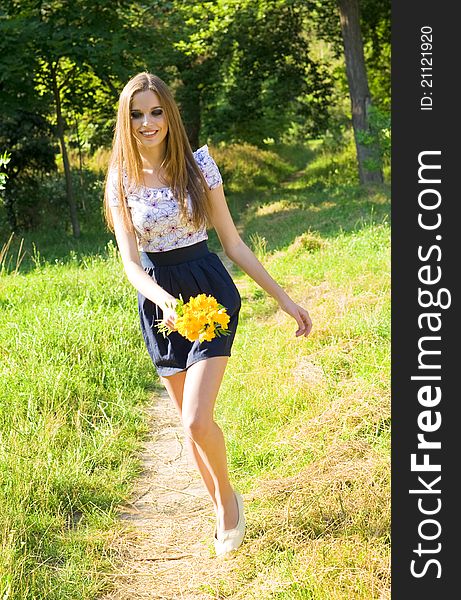 Portrait of a happy young girl smiling outdoor in summertime