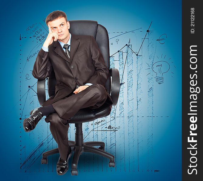 Portrait of young businessman sitting on chair against graph background