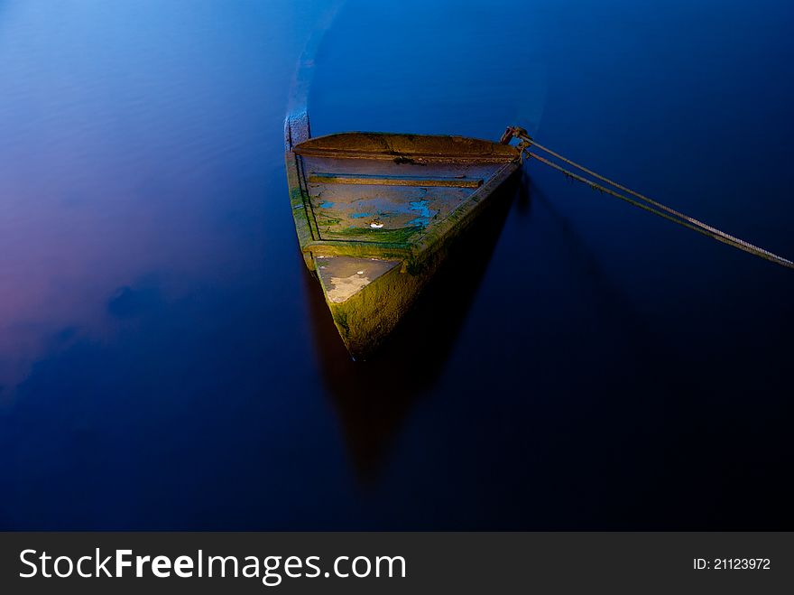 Phantasmagoric scene with sunk boat and dark water. Phantasmagoric scene with sunk boat and dark water