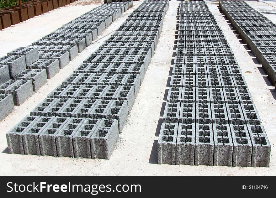 Concrete blocks used to build houses, buildings, office buildings. Gray. Composition: cement, sand and lime. Perspective look. Factory of cement blocks. Concrete blocks used to build houses, buildings, office buildings. Gray. Composition: cement, sand and lime. Perspective look. Factory of cement blocks